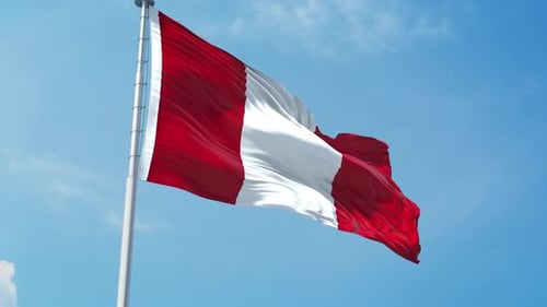 Peruvian Flag Waving Against a Clear Blue Sky
