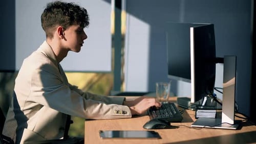 Young man is working in a computer in an office