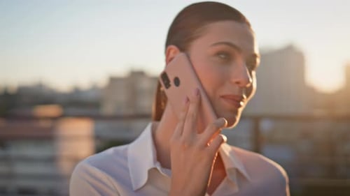 Smiling Woman Talking on Phone at Golden Hour
