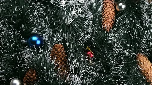 Christmas Spinning Background of Green Christmas Tinsel or Artificial Pine Needles or Christmas Tree