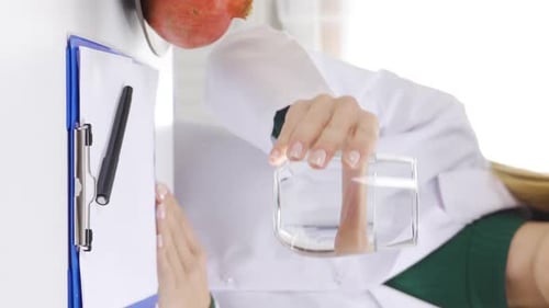 Doctor Holding Glass of Water in Office