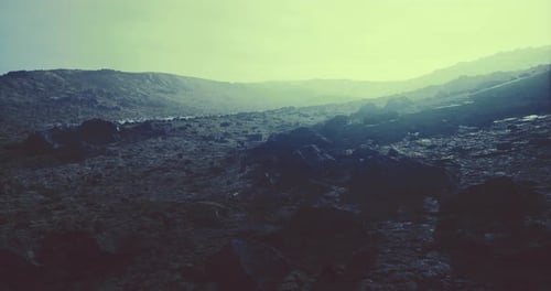 Expansive Rocky Terrain Under an Ethereal Sky at Dusk