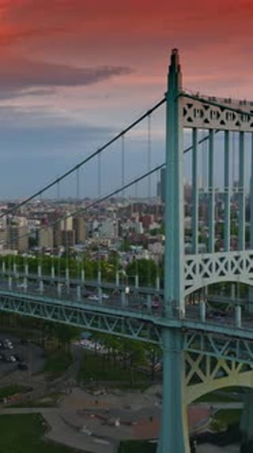Triborough Bridge under the blue and red sky at sundown.