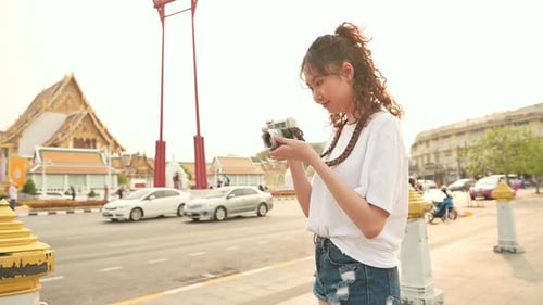 Beautiful young Asian tourist woman on vacation sightseeing and exploring Bangkok city