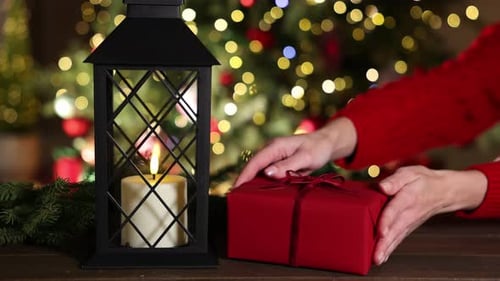 Gift Wrapping Near Christmas Tree and Lantern