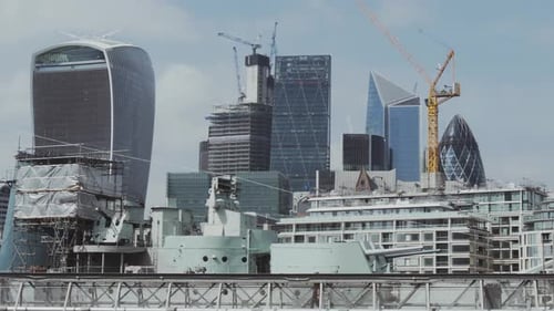 London- The City of London Skyline (Walkie Talkie, Cheese Grater, Gherkin) with HMS Belfast in the f