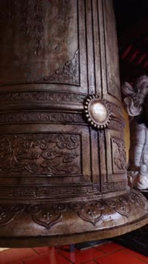 Ornate Bronze Bell with Asian Inscriptions in Temple