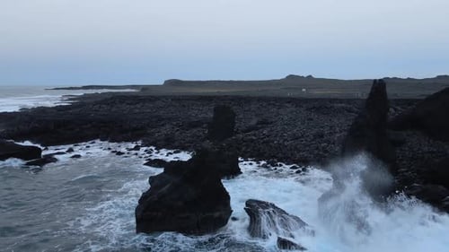 Aerial Seascape South Coast of Iceland. Waves Crashing to Black Rocks on Shore