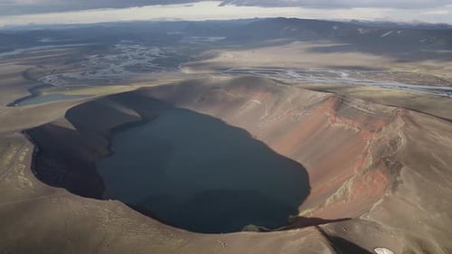 Aerial backwards shot volcanic landscape with crater lake in Iceland - Beautiful landscape on island