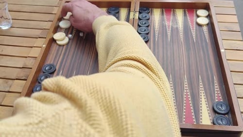 Two Men Playing A Traditional Game Of Backgammon