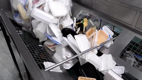 Disposable Food Packaging Waste on Recycling Conveyor Belt