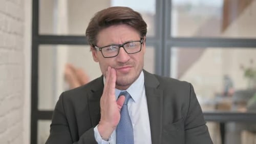 Uncomfortable Businessman with Toothache in Office
