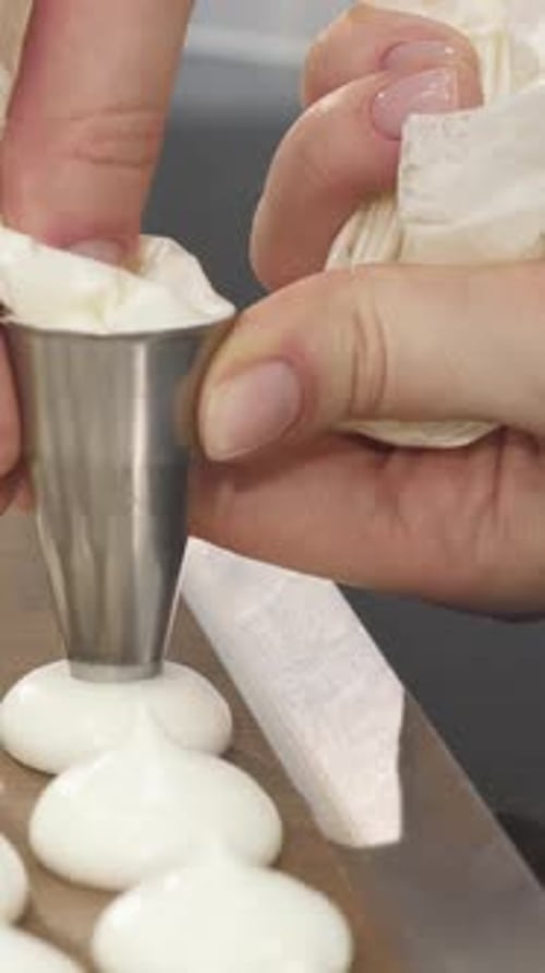 Confectioner Expertly Piping Meringue Cookies Onto a Baking Tray