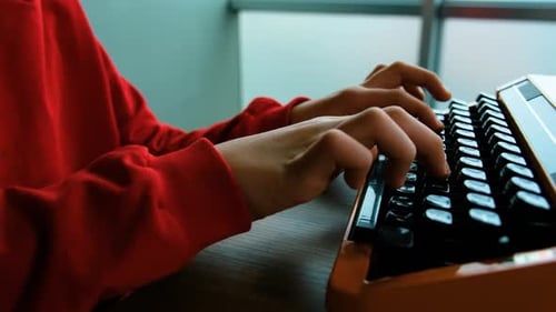 Writing letters with orange retro vintage typewriter