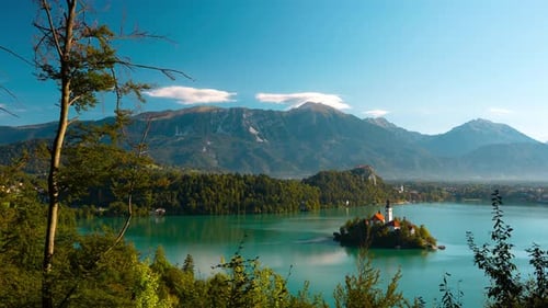 Scenic lake Bled island with church and medieval castle on lakeshore