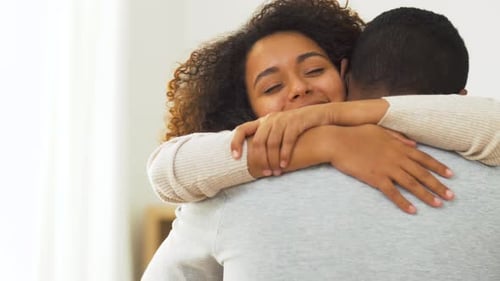 Loving Woman Embraces Man Affectionately Indoors