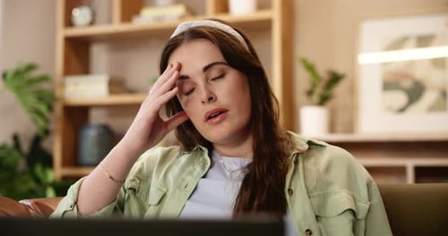 Woman Working on Laptop Looking Concerned at Home