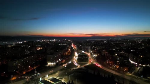 Aerial View of Varna Bulgaria at Sunset Showcasing a Vibrant Cityscape with Illuminated Streets
