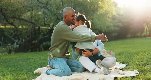 Nature, happy and child hugging her parents at an outdoor park while on a picnic together