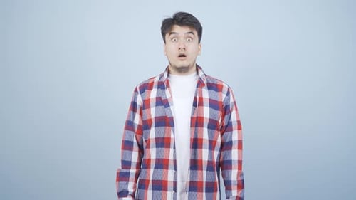 Man Looks Shocked at Camera with Mouth Open
