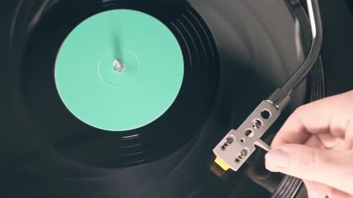 Vinyl Retro record on DJ turntable record player close up. Black vinyl background with green screen