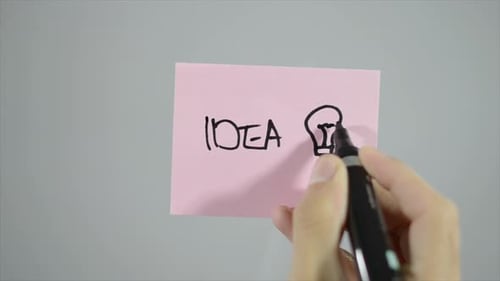 Drawing an Idea Lightbulb on Pink Note