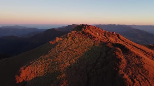 Aerial video of Mount Pulag at sunset with people in the background, the third highest mountain