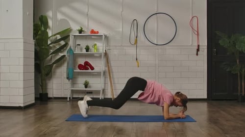 Woman Practicing Yoga in Modern Gym Environment