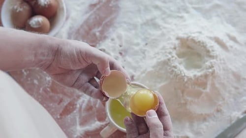 Hands Separate Egg Yolk for Baking