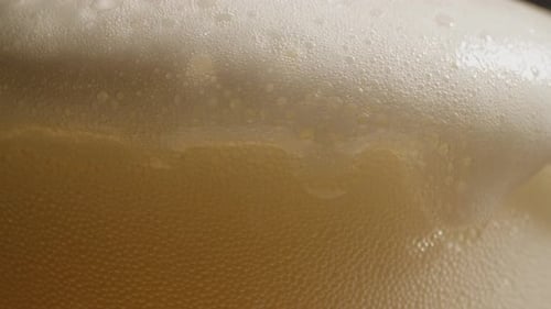 Bubbles and Foam of Golden Beverage Close-up