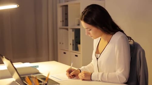 Business, Overwork, Deadline and People Concept - Woman with Laptop and Papers