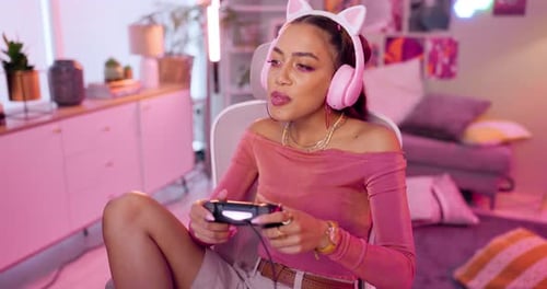 Woman Playing Video Game with Headphones at Home