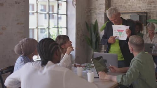 senior manager showing sales process and amount potential revenue using funnel chart to multicultura