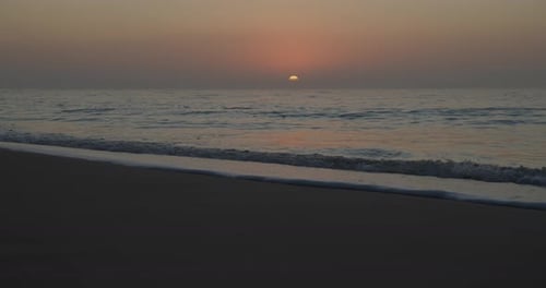 Golden Sunset on Tranquil Beach with Gentle Waves