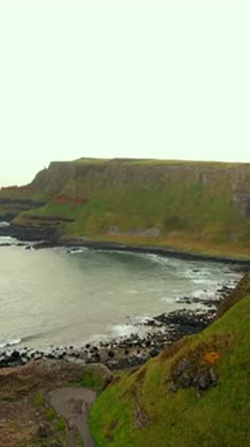 Wide sunrise social ratio aerial video of The Giant's Causeway in Bushmills, Northern Ireland