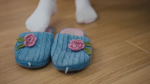 Small Feet Stepping Into Cozy Slippers