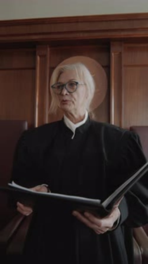 Judge Holding Law Book in Courtroom