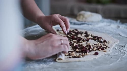 Rolling Dough with Chocolate and Berries Filling