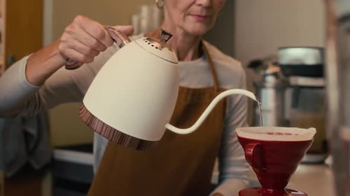 Woman Prepares Pour Over Coffee at Cafe