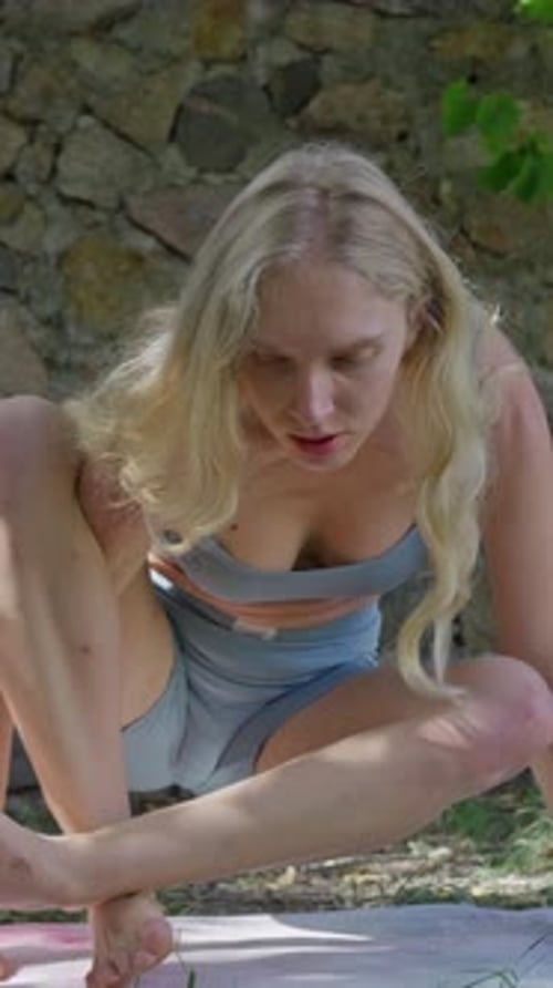 Blonde Woman Practicing Yoga Outdoors on Sunny Day