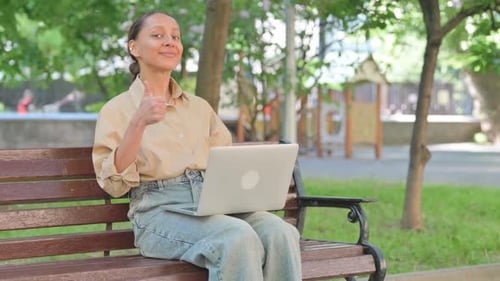 Adult Working on Laptop in Park Sitting on Bench