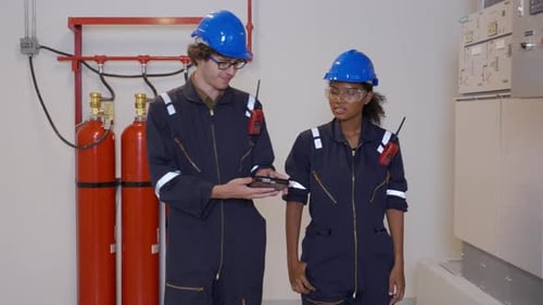 Engineers Discussing on a Tablet in Industrial Setting