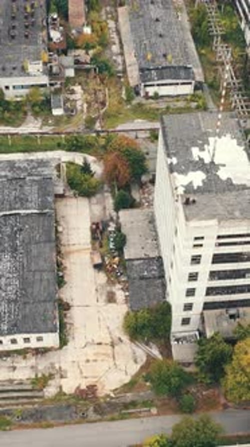 Aerial view of industrial destroyed city buildings. View from above of ruined and abandoned factory.