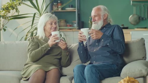 Senior Couple Drinking Coffee at Home Together
