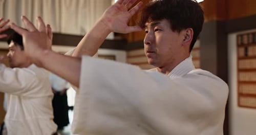 Adults Practicing Martial Arts in Studio