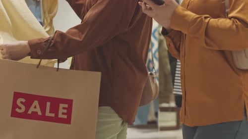Women with Shopping Bags in Clothes Store