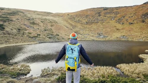 Hiker Admiring Mountain Lake View