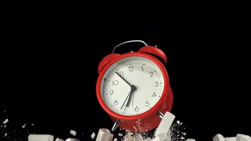 Alarm Clock and School Crayons Fly Up on a Black Background Filmed on a Highspeed Camera at 1000 Fps
