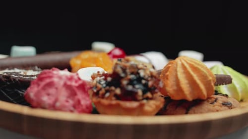 A Sweets and Colorful Candy are Rotating on the Plate