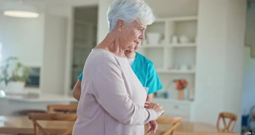 Caregiver, retirement and old woman in wheelchair of nursing home for medical services